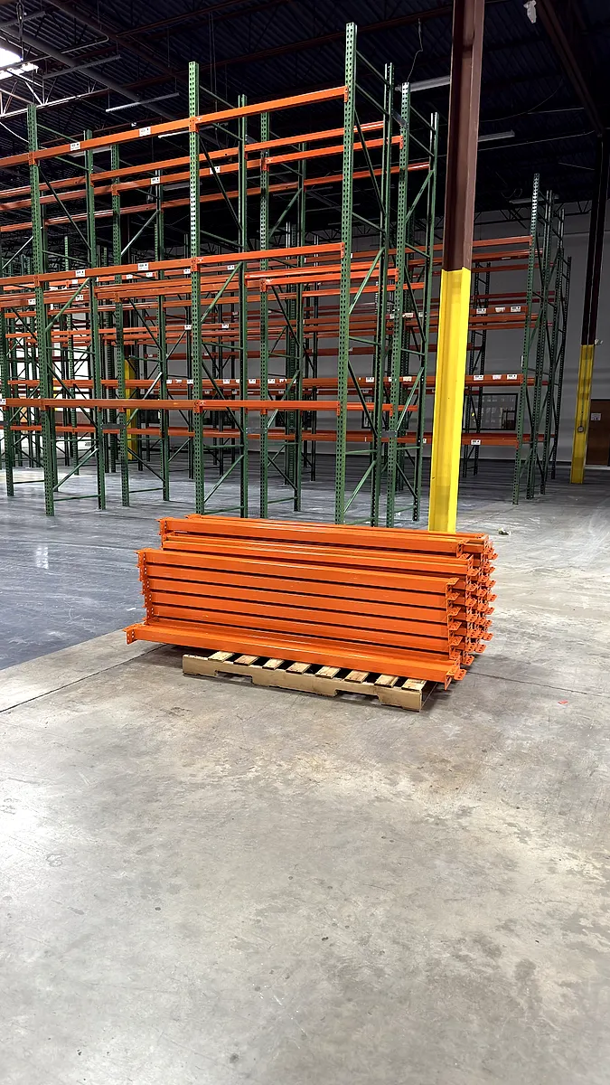 Pallet rack beams banded on a pallet beside new rack