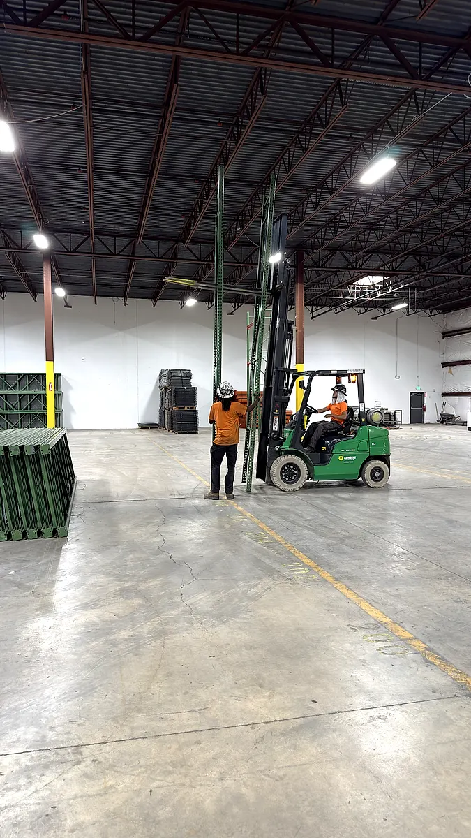 Forklift moving upright frames on a racking job