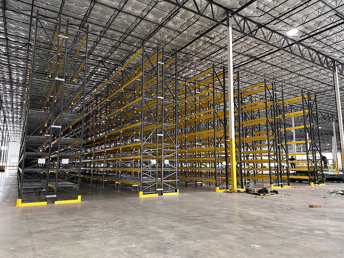 Warehouse laid out with rows of new pallet rack by Alliance