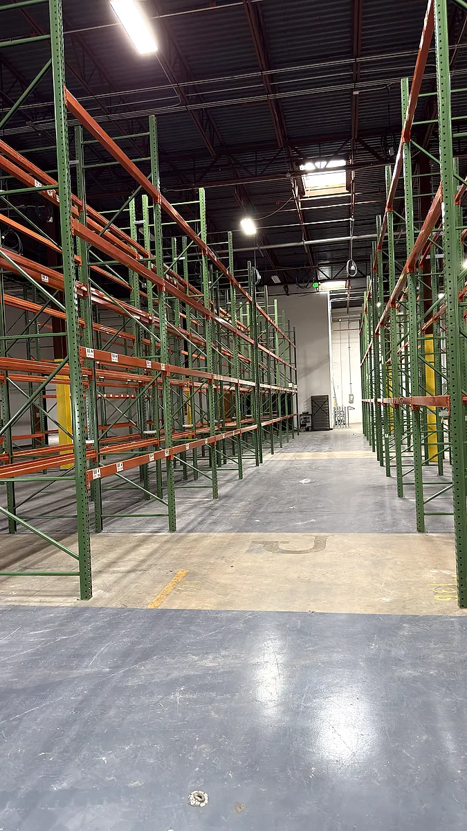 Pallet rack aisle with uprights and beam levels in view for inspection