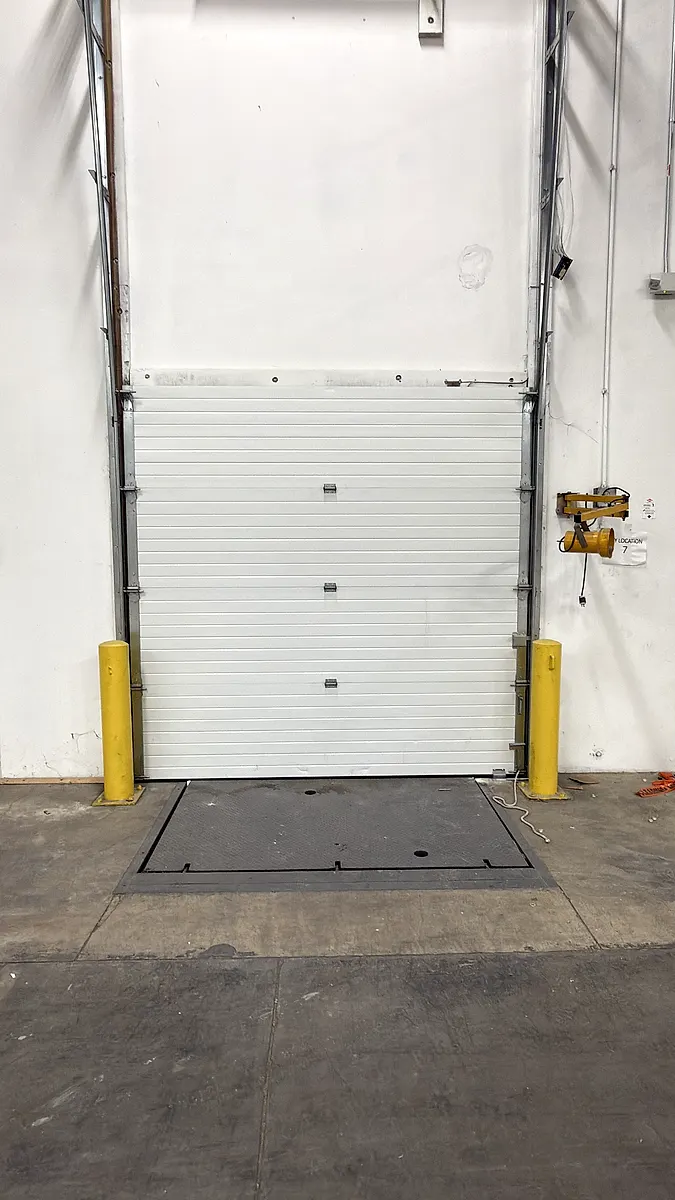 Dock door with protective bollards