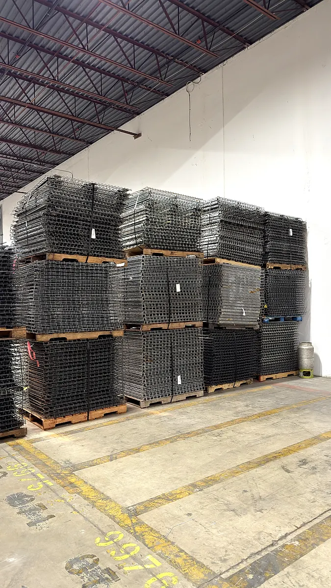 Wire deck panels stacked on pallets