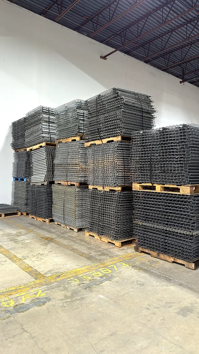 Pallets of wire decking stacked in a warehouse